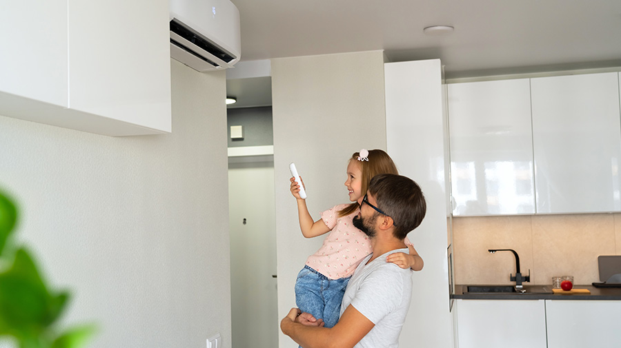 Father and child using an air conditioning unit