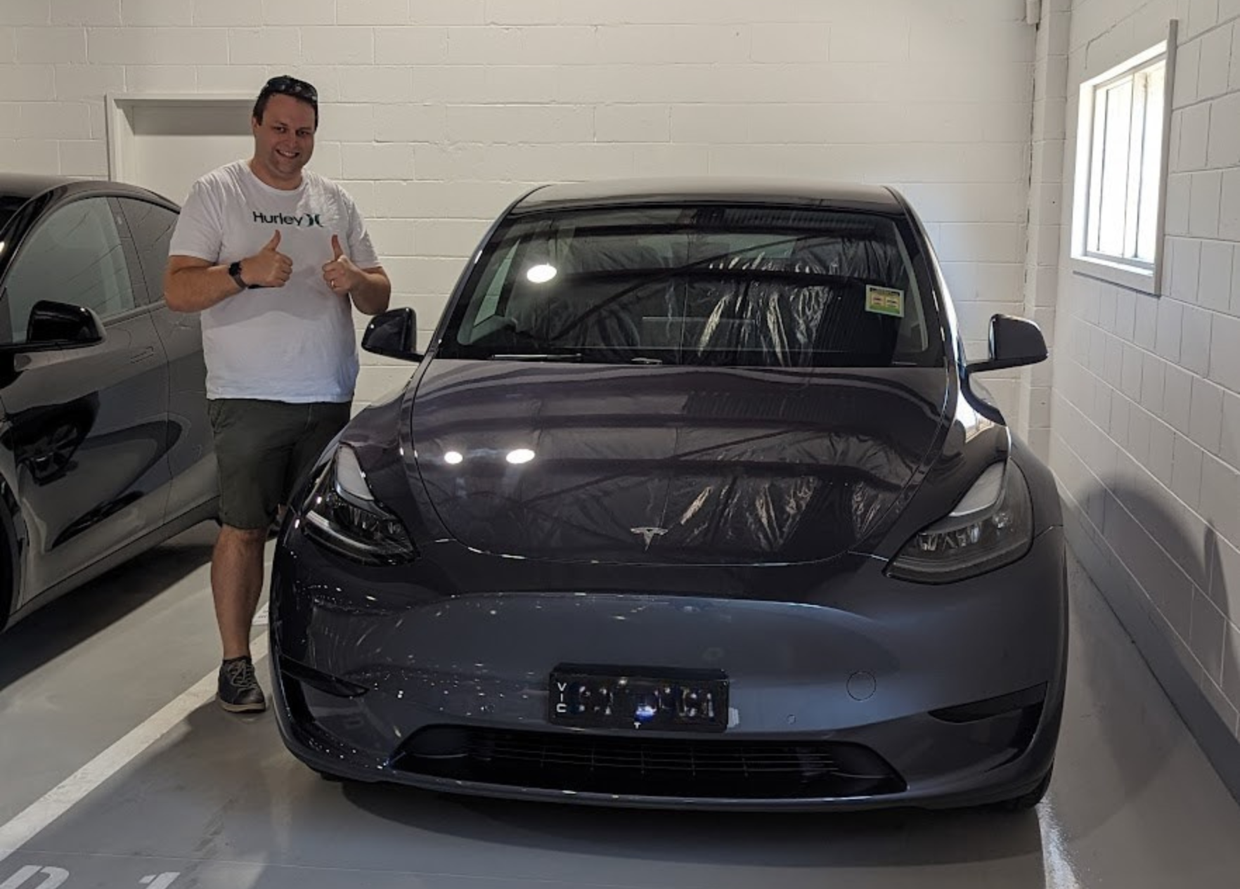 Michael standing next to his new car
