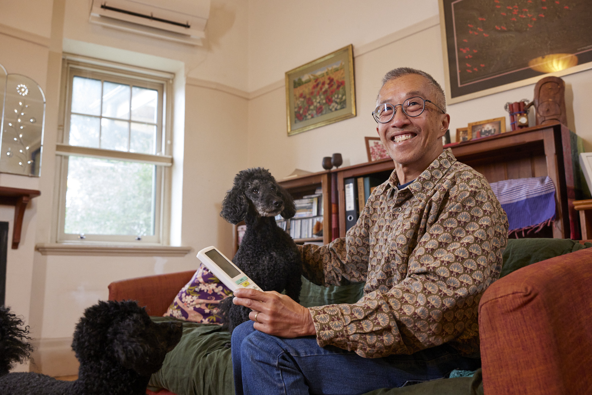 Terry Teoh on couch with dogs