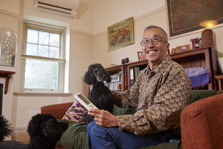 Terry Teoh on couch with dogs